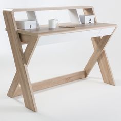 a wooden desk with two drawers and a laptop on it, sitting in front of a white background