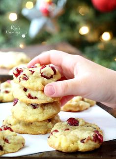 a hand picking up a cranberry white chocolate chip cookies