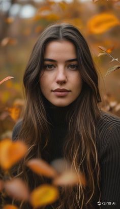 a woman with long hair standing in leaves