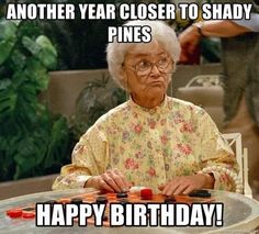 an old woman sitting at a table with candles on it and the caption says, another year closer to shady pines happy birthday