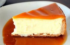 a piece of cheesecake covered in caramel sauce