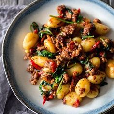 a close up of a plate of food with potatoes and spinach on the side