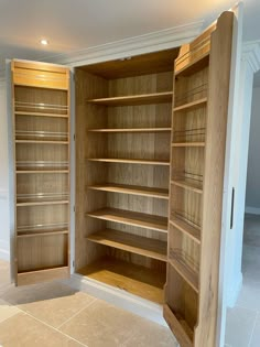 an empty room with wooden shelves and tile flooring