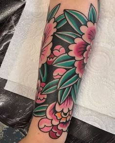 a person with a flower tattoo on their arm