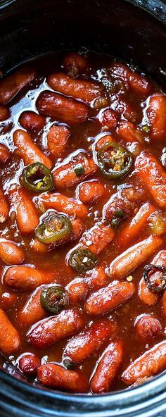 a crock pot filled with carrots and peppers