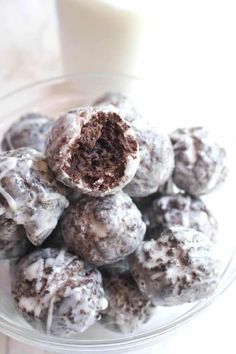 chocolate munchkins are stacked on top of each other in a glass bowl with the words glazed chocolate munchkins donut holes