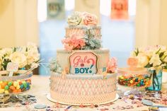 a cake that is sitting on top of a table with candy and candies around it