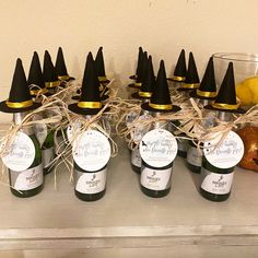 there are many bottles of wine with witches hats on them and some lemons in the background