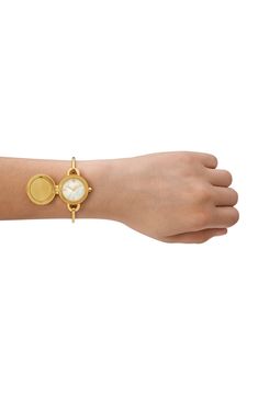 A signature, double-T logo decorates the dial of a goldtone bangle watch with three interchangeable charms. 27mm case; 5mm band width Three-hand quartz movement Mother-of-pearl dial Stainless steel/goldtone plate Imported Dainty Watches For Women, Gold Bangle Watch, Charm Watch, Golden Watch, Watch Set, Bangle Watches, Green Hills, Perfume Gift Sets, Gold Bracelet For Women