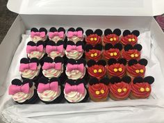 a box filled with lots of cupcakes covered in minnie mouse ears