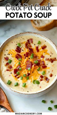 a bowl of potato soup with bacon, cheese and green onions