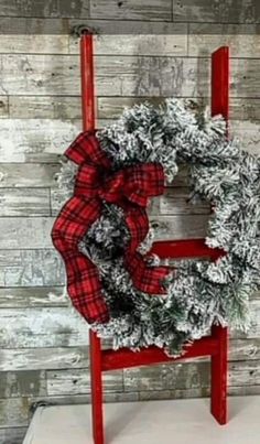 a red chair with a christmas wreath on it