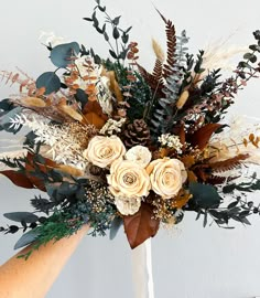 a bouquet of flowers is being held by someone's hand