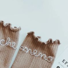 two pairs of socks with the word memee written on them, sitting next to each other