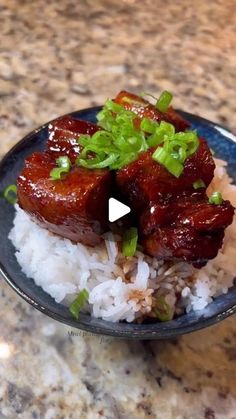 a bowl filled with rice and meat on top of a counter