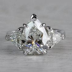 an engagement ring with three pear shaped diamonds