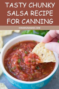 a hand holding a tortilla chip with salsa in it and the words tasty chunky salsa recipe for canning