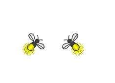 a pair of yellow and black bee earrings on a white background with the words bees