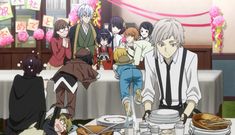 an anime scene with people sitting at a table and one person standing in front of the table