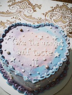 a heart shaped cake with the words be the moment and taste on it's frosting