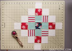 a close up of a piece of fabric on a cutting board with a sewing needle