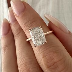 a woman's hand with a diamond ring on it