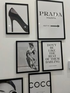 black and white photographs hang on the wall above heels, shoes, and other items