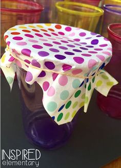 there are many cups that have polka dot designs on them, and one has a bow around the top