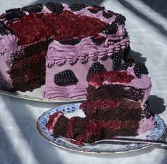 a piece of cake on a plate with a fork next to it and another slice missing