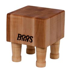 a small wooden stool with the word boss on it's side and black lettering