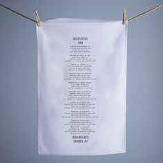 a sheet of paper hanging from a clothes line with words written on the front and back