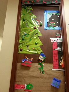 a door decorated for christmas with presents and decorations on the front, and a tree in the back