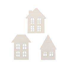 three pieces of white paper cut out of houses on a white background, with windows and shutters