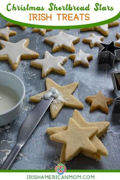 christmas shortbread stars are on the table next to a bowl of milk