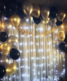 a birthday party with balloons and streamers on the curtained wall, happy birthday