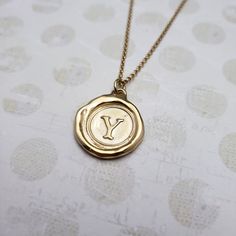 "Monogram Initial letter \"Y\" Materials: Silver, Gold, Gold vermeil Gold vermeil is a thick 24k layer of gold over a solid sterling silver base. Size: Approx 3/4\" {21mm} The antique wax seals used to make my initials are mostly around 170 yrs but can be as young as 70 yrs, and as old as 750+ yrs old (My letter i). As each wax seal was individually collected, I am unable to change the font or size. They are only available as shown. PLEASE NOTE: Before you order please check sizing information - it can be hard to gauge jewelry sizes from pictures alone. On some of the seal pieces the text is so small as to be read only with a magnifying glass making the meaning a secret between you and those you choose to tell. Availability and shipping Your purchase will ship in 3-5 business days. Once sh Classic Gold Stamped Necklace, Gold Stamped Initial Pendant Necklace, Gold Stamped Initial Pendant Charm Necklace, Gold Stamped Pendant Charm Necklace, Monogram Wax Seal, Wax Seal Pendant, Seal Jewelry, Jewelry Letter, Wax Seal Jewelry