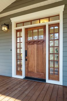 the front door is open and there are two doors on each side of the house