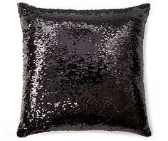 a black sequin pillow on a white background