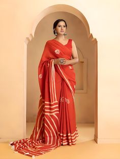 This beautiful handmade Batik print saree is a celebration of traditional Indian craftsmanship. Made from pure cotton, the saree is soft, breathable, and comfortable, perfect for all-day wear. With a length of 6.4 meters, it drapes elegantly, showcasing intricate Batik designs that are both timeless and stylish. The accompanying blouse piece measures 0.90 meters, allowing for a perfect fit. Ideal for both casual and festive occasions, this saree adds a touch of grace and sophistication to any wardrobe. - **Material Pure Cotton for ultimate comfort and breathability. - **Design Traditional Batik print, showcasing intricate handmade designs. - **Saree Length 6.4 meters, providing ample fabric for elegant draping. - **Blouse Piece Includes a 0.90-meter blouse piece, customizable for a perfect Orange Bandhani Print Blouse Piece, Festive Cotton Pre-draped Saree With Block Print, Bollywood Style Cotton Pre-draped Saree For Puja, Bollywood Cotton Pre-draped Saree For Wedding, Cotton Pre-draped Saree For Puja During Navratri, Festive Cotton Pre-draped Saree With Pallu, Cotton Silk Saree With Block Print For Festivals, Cotton Pre-draped Saree With Unstitched Blouse For Wedding, Bollywood Style Batik Print Saree For Diwali