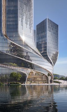 an artistic view of some very tall buildings by the water with reflections on the surface