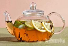 a glass tea pot filled with lemon and lime