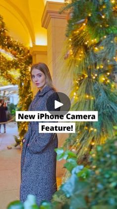 a woman standing in front of a christmas tree with the words new iphone camera feature