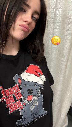 a woman wearing a black shirt with a santa hat on