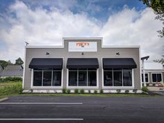 the front of a building with awnings and windows