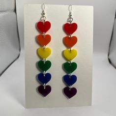 Rainbow heart earrings! Wear your pride and look sexy instead of like a weird corporate shill. Gay earrings made 100% by a gay person. Look cool feel cool. Crafted from high-quality acrylic, with sterling silver plated hypoallergenic ear hooks. They are lightweight and comfortable to wear, making them suitable for everyday use or special occasions. Each piece is designed, laser cut, and assembled in my Berkeley studio. Rainbow Heart Earrings For A Gift, Gay Earrings, Pride Jewelry Earrings, Rainbow Heart-shaped Earrings As Gift, Handmade Heart-shaped Novelty Earrings, Lgbtq Earrings, Vibrant Rainbow Dangle Earrings, Rainbow Heart, Ear Hook