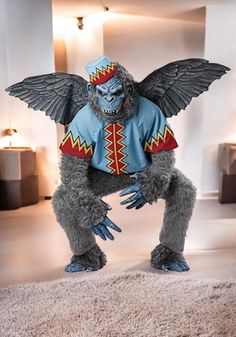 a man dressed as a gorilla standing on top of a rug