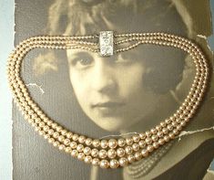 "Offering the most beautiful VERY well made vintage Art Deco champagne/rich warm ivory multi/three strand glass pearl and paste rhinestone statement necklace perfect for the Bride.  The three strands of lustrous glass pearls used on this necklace are graduated in size and have unbelievable luster.  Glass pearls mimic natural pearls in weight and luster.  The strands come together with a gorgeous, SO Art Deco, ornate embossed rhodium plated pinch box clasp that is pave set with BRILLIANTLY clear Art Deco Champagne, Pearl Necklace Bridal, Ivory Pearl Necklace, Multi Strand Pearl Necklace, Vintage Rhinestone Jewelry, Rhinestone Statement Necklace, Necklace Bridal, Art Deco Necklace, Ivory Pearl