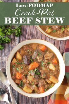 two bowls filled with beef stew on top of a wooden table