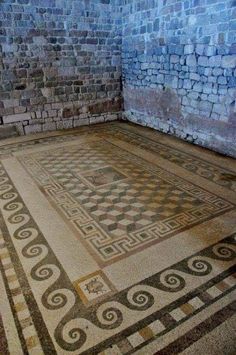 an old room with some very pretty designs on the floor and walls, but no one is in it