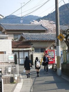 some people are walking down the street together